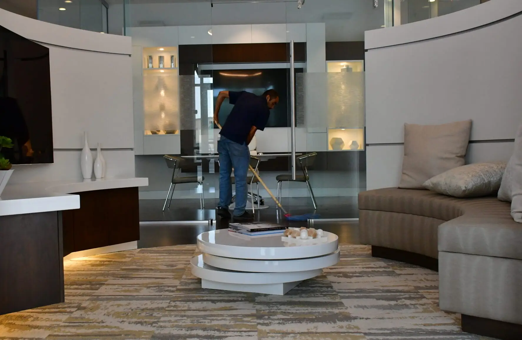 custodian mopping a large entryway seating area.