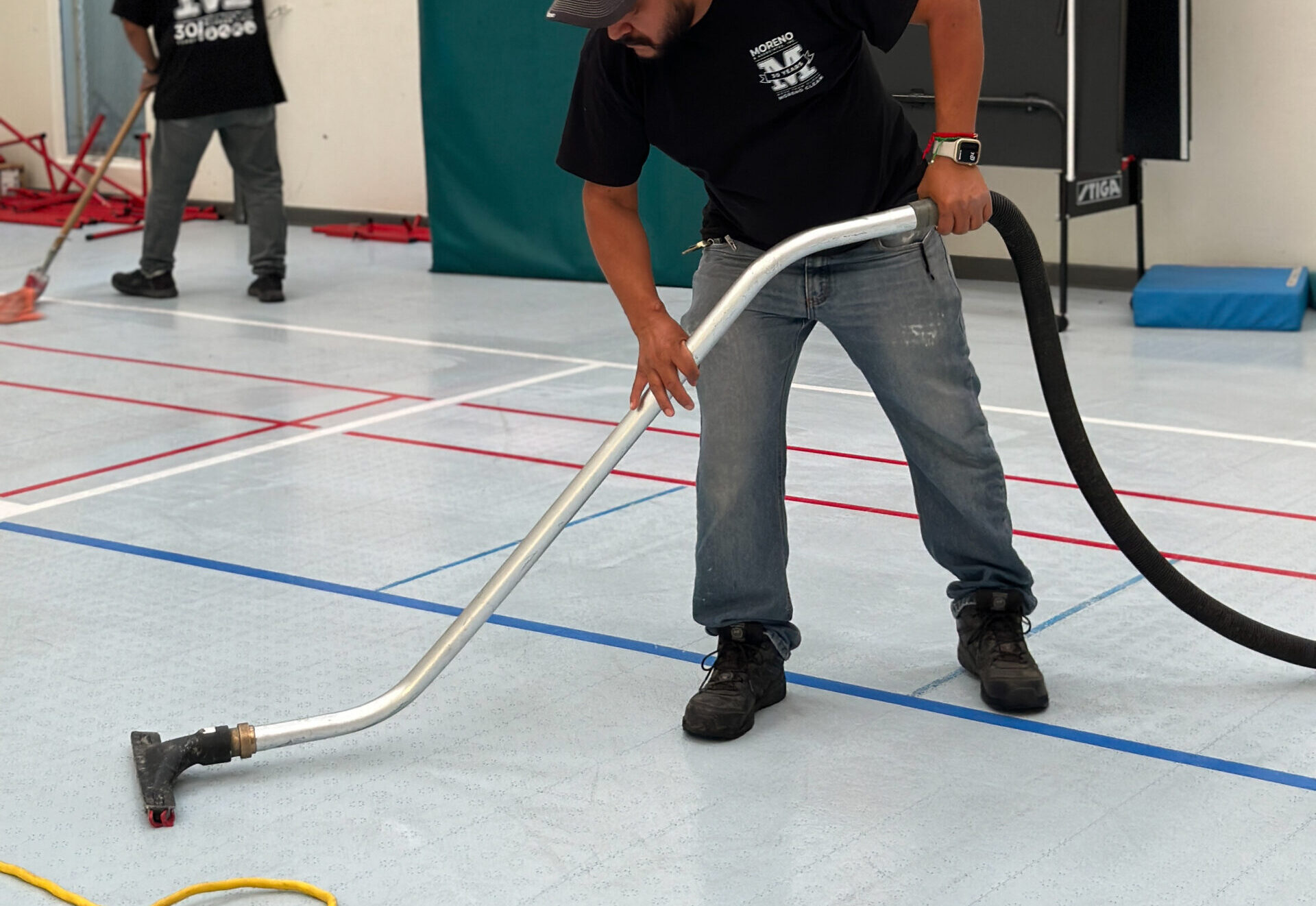 man using a water extraction tool on floor